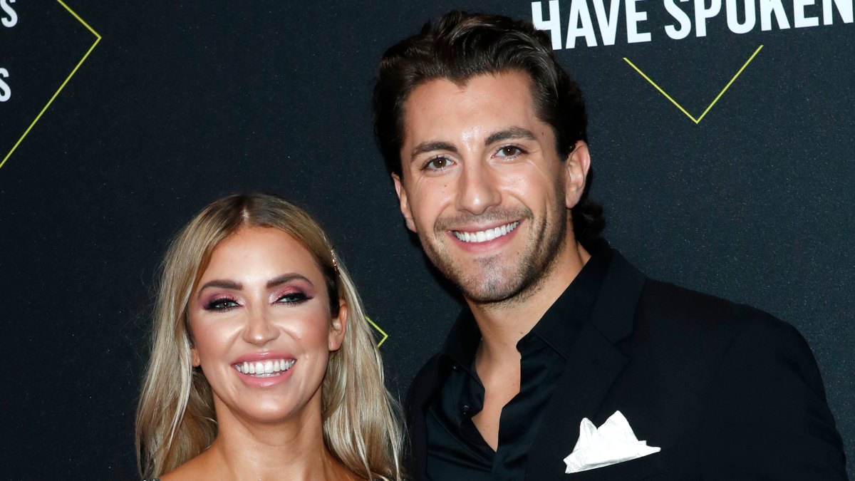 Kaitlyn Bristowe and Jason Tartick smiling for pictures on the red carpet at the 2019 People's Choice Awards