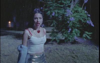 Olivia Rodrigo walking through rain in her Bad Idea Right music video