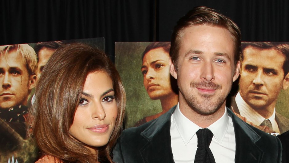 Eva Mendes wearing an orange dress posing next to Ryan Gosling at the premiere of The Place Beyond the Prines