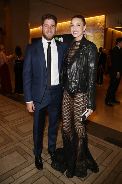 Tim Rosenman wearing a blue navy suit and Whitney Port wearing a black leather jacket and fishnet leggings