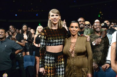 Taylor Swift and Kim Kardashian posing at the 2015 MTV VMAs.