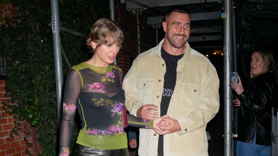 Travis Kelce and Taylor Swift hold hands as they leave a restaurant.