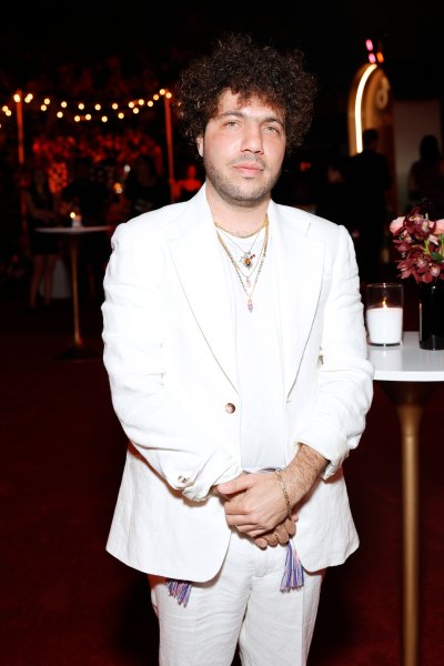 Benny Blanco poses while wearing an all-white suite