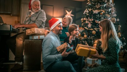 multigeneration family on the living room exchancing christmas presents