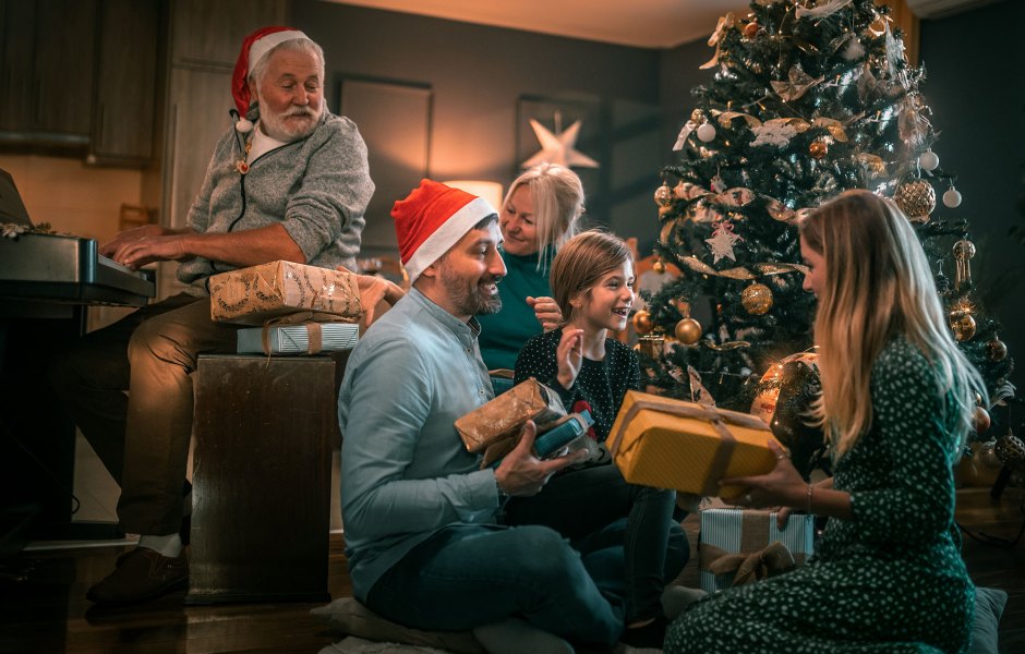 multigeneration family on the living room exchancing christmas presents