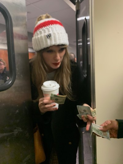 Taylor Swift handing cash to kitchen staff during the Chiefs vs. Patriots game.