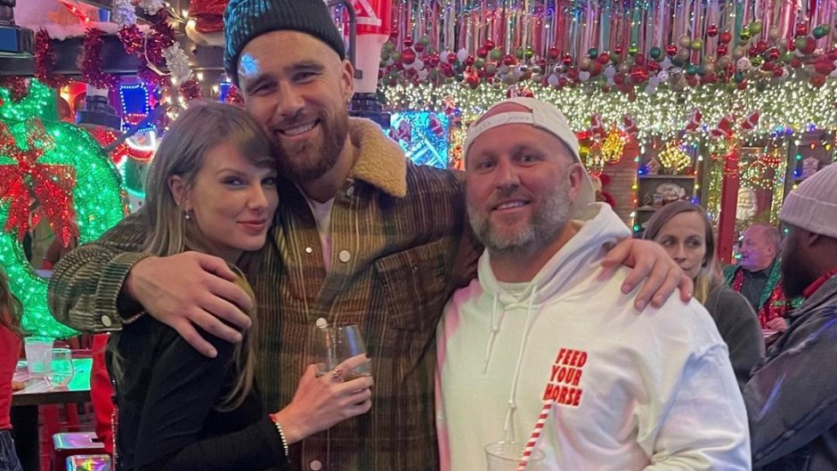 Travis Kelce with his arm around Taylor Swift and a fan during a Christmas party