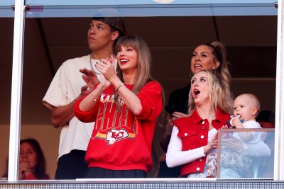 Taylor Swift cheers on Travis Kelce at the Chiefs vs. Chargers game wearing a red Kansas City Chiefs sweatshirt.