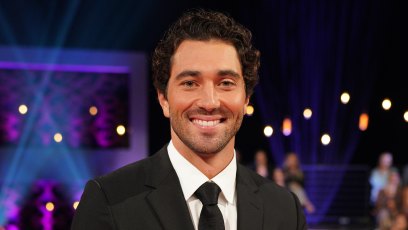 Joey Graziadei wearing a black suit and tie