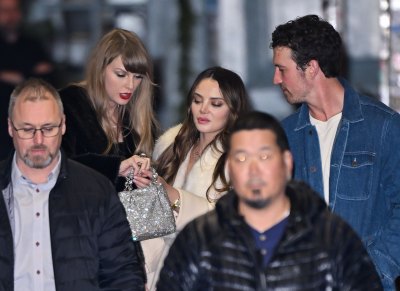 Taylor Swift shows her opal ring to Keleigh Sperry and Miles Teller