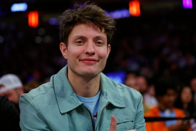 Matt Rife wearing a bluish green jacket at an NBA game.