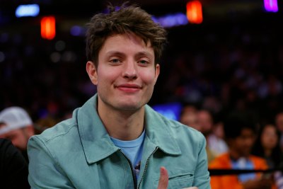 Matt Rife wearing a bluish green jacket at an NBA game.