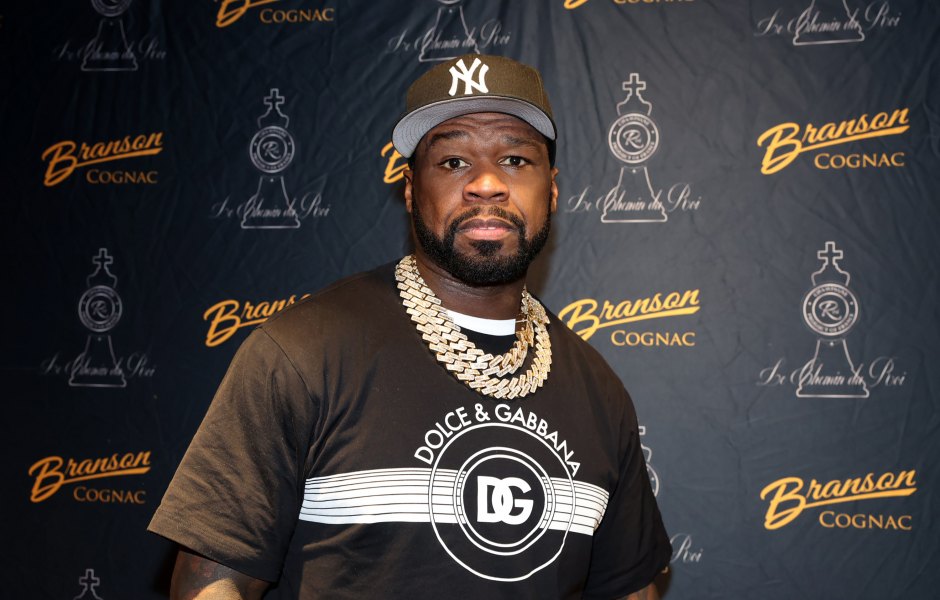 50 Cent promotes Branson cognac while wearing a black Dolce & Gabbana shirt and black New York Yankees hat