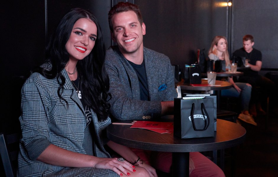 Adam Gottschalk sits next to Raven Gates at a table.