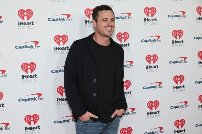 Ben Higgins wears a black shirt and jacket with jeans