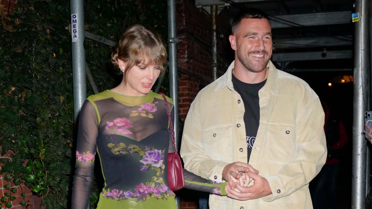 Taylor Swift and Travis Kelce hold hands as they leave an NYC restaurant