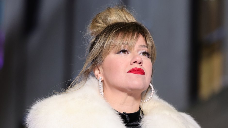 Kelly Clarkson wears her hair in an updo with a fur coat and black top underneath