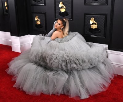 Ariana Grande poses in a gray dress on the red carpet