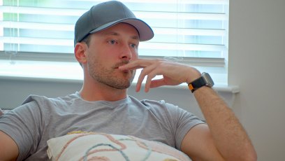 Love Is Blind's Jeramey Lutinski wearing a gray T-shirt and a cap during a still shot from Love Is Blind season 6