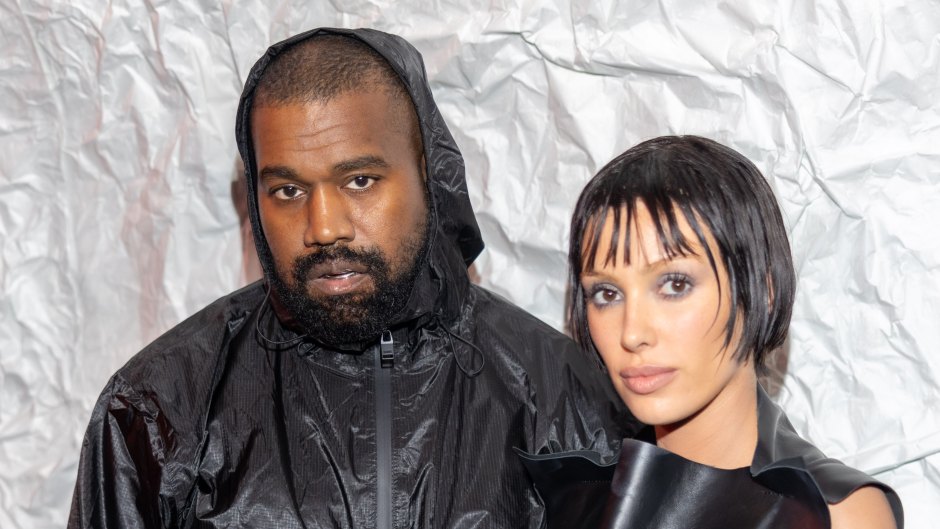 Kanye West and Bianca Censori pose for a photo during Milan Fashion Week while both wear all black.