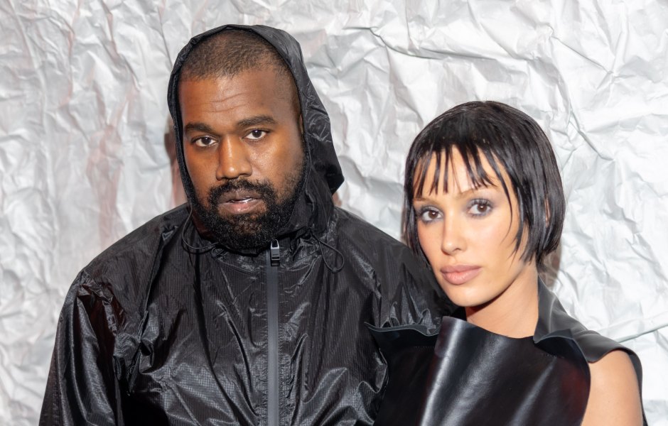 Kanye West and Bianca Censori pose for a photo during Milan Fashion Week while both wear all black.