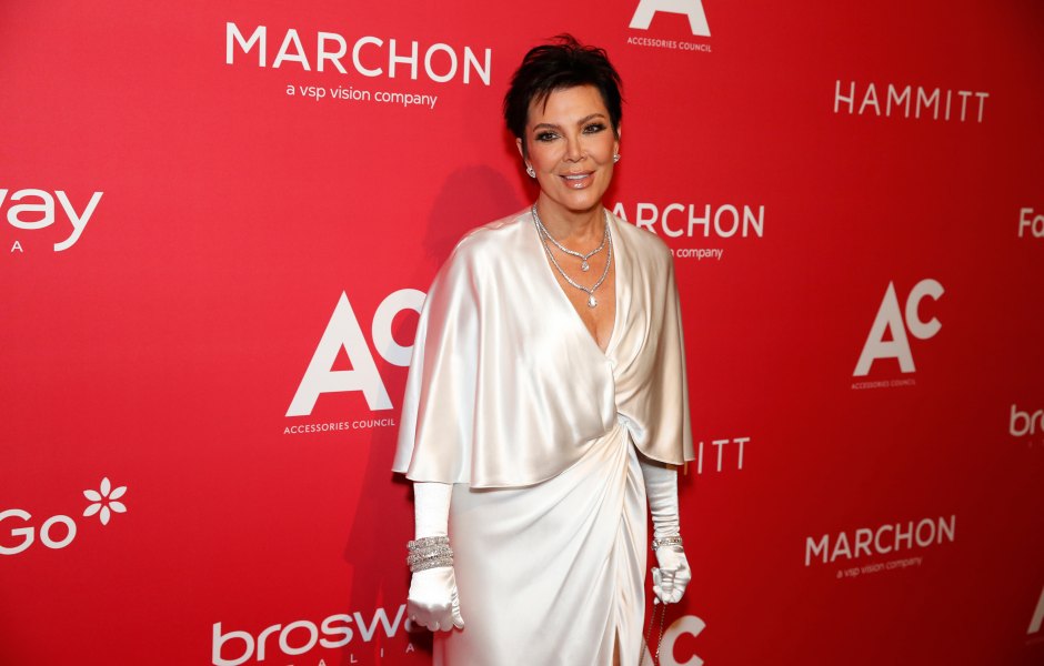 Kris Jenner poses in a white satin dress with white gloves.