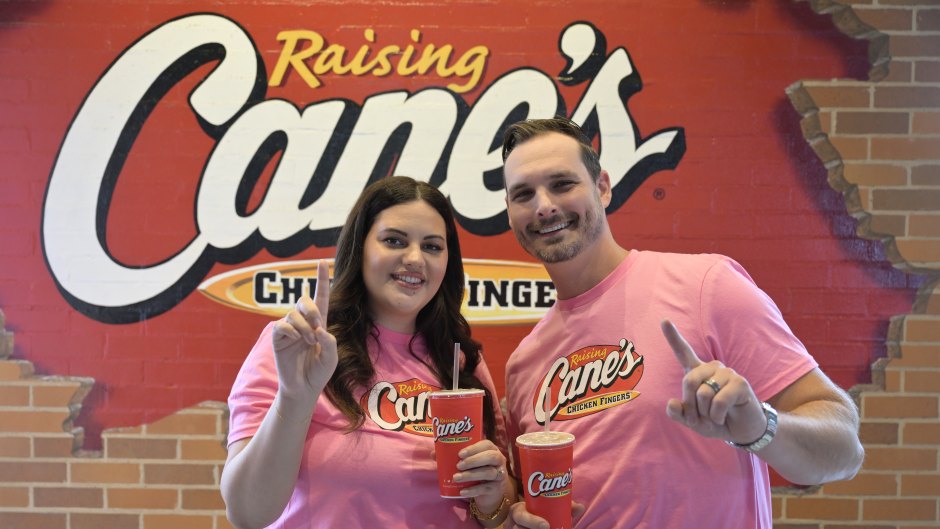 Love Is Blind stars Alexa and Brennon Lemieux pose for photos at a Raising Cane's event.
