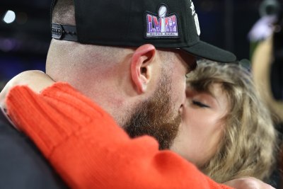 Travis Kelce and Taylor Swift kiss after the AFC championship