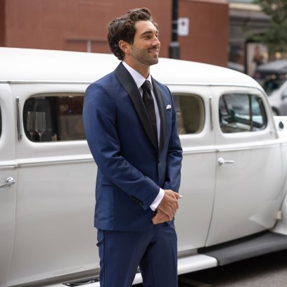 The Bachelor's Joey Graziadei standing in front of a white car in a still shot from season 28.