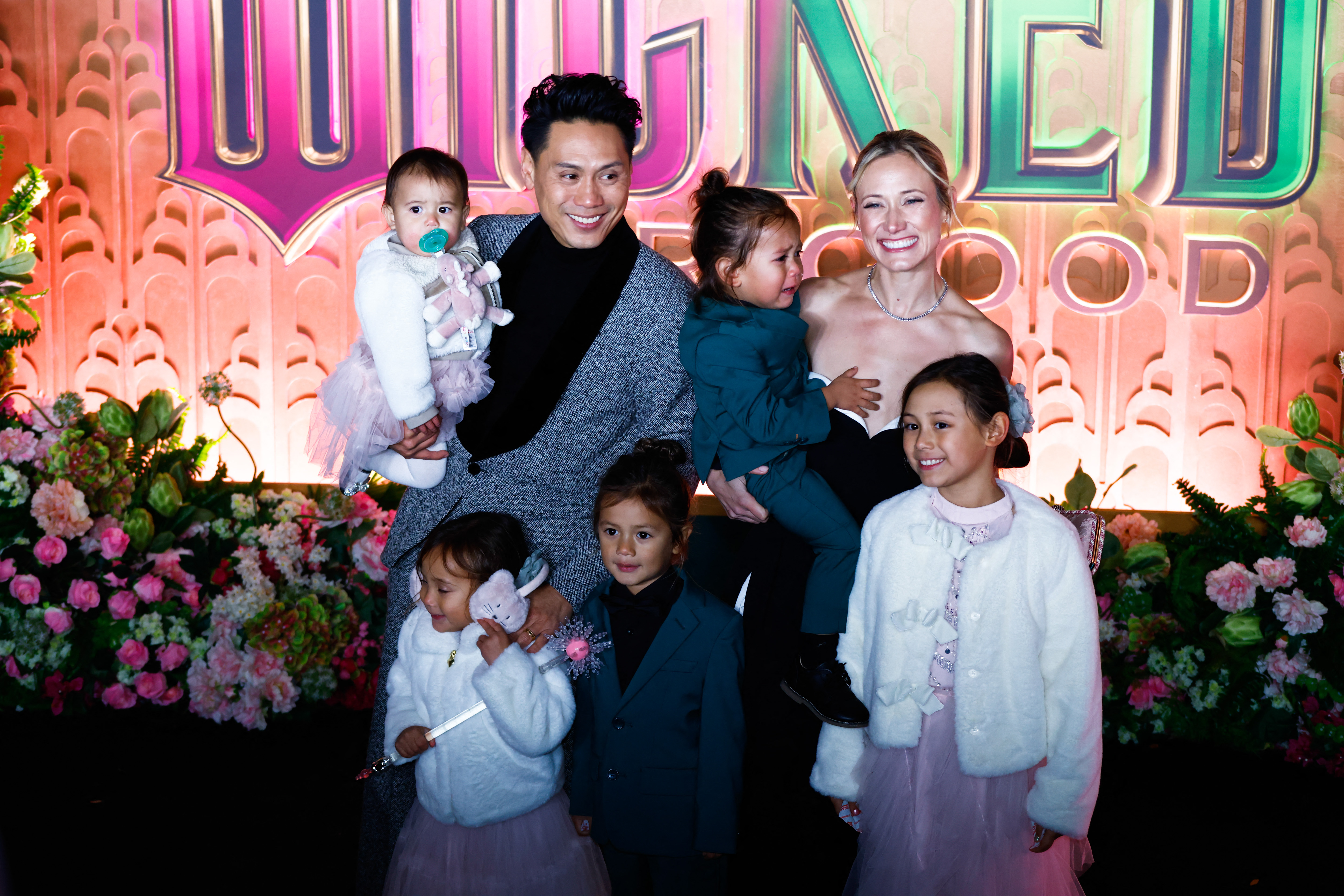 2246702518 US director Jon M. Chu with his wife graphic designer Kristin Hodge and their children attend the premiere of "Wicked: For Good" at Lincoln Center for the Performing Arts in New York on November 17, 2025. (Photo by kena betancur / AFP) (Photo by KENA BETANCUR/AFP via Getty Images)