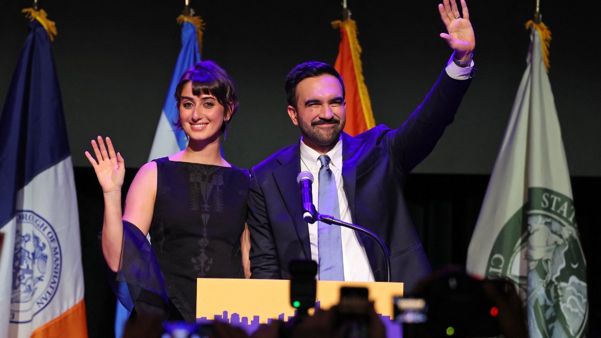New York City Mayoral candidate Zohran Mamdani (R) celebrates alongside his wife Rama Duwaji (L) during an election night event at the Brooklyn Paramount Theater in Brooklyn, New York on November 4, 2025. New Yorkers elected leftist Zohran Mamdani as their next mayor November 4, 2025 broadcasters projected, on a day of key local ballots across the country offering the first electoral judgement of Donald Trump's tumultuous second White House term. (Photo by ANGELA WEISS / AFP) (Photo by ANGELA WEISS/AFP via Getty Images)