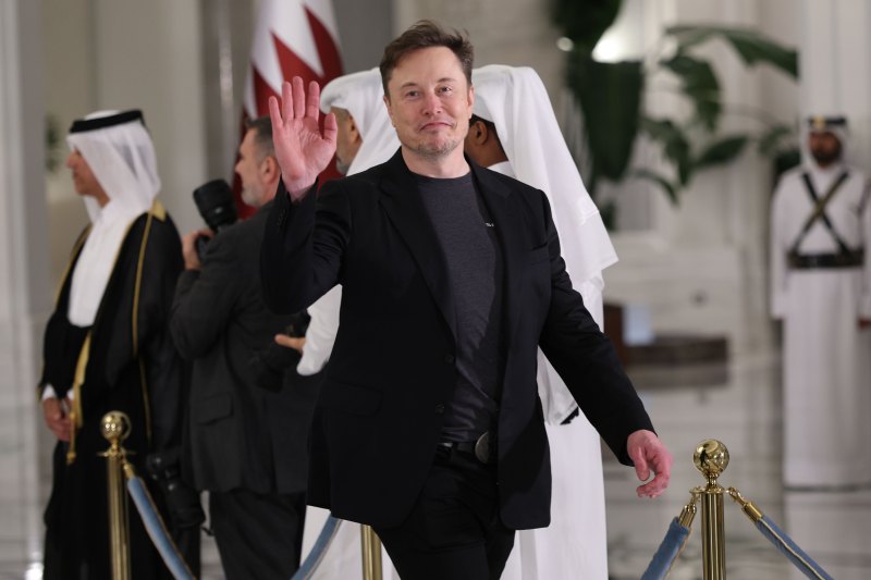 DOHA, QATAR - MAY 14: Elon Musk waves as he arrives for a state dinner at the Lusail Palace on May 14, 2025, in Doha, Qatar. The visit underscores the strategic partnership between the United States and Qatar, focusing on regional security and economic collaboration. (Photo by Win McNamee/Getty Images)