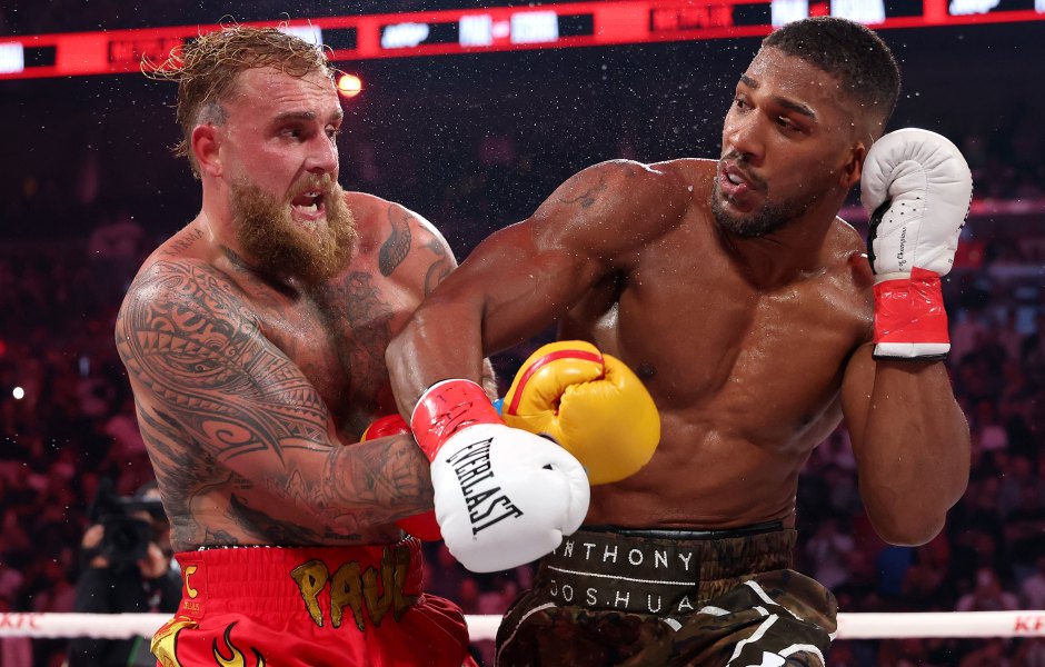 MIAMI, FLORIDA - DECEMBER 19: (L-R) Jake Paul fights Anthony Joshua in their heavyweight bout during Jake Paul v Anthony Joshua at Kaseya Center on December 19, 2025 in Miami, Florida. (Photo by Ed Mulholland/Getty Images for Netflix)