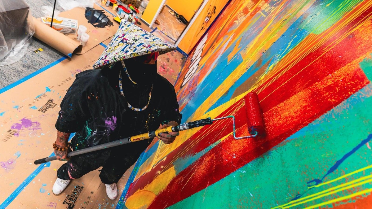 Artist Super Buddha painting SuperSure’s Wells Fargo Center Penthouse Office