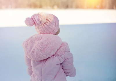 young girl wearing winter jacket in snow