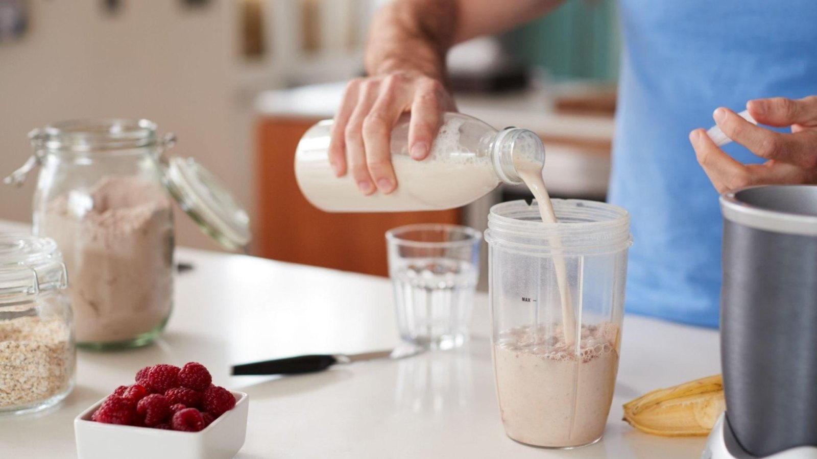 FlavCity protein powder with smoothie ingredients on a kitchen counter