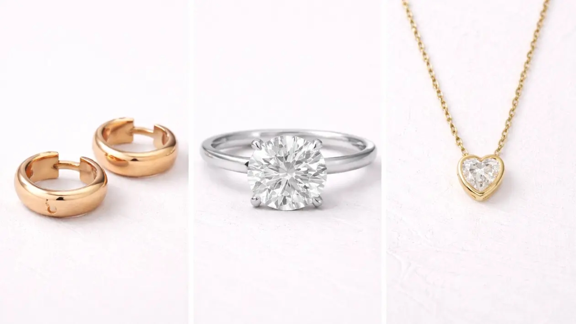 Gold hoop earrings, a diamond solitaire ring, and a heart-shaped diamond pendant necklace displayed on a neutral background
