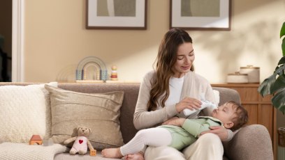 Parent using Momcozy baby care essentials with an infant during a daily care routine.