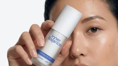 Woman applying Inner Balance BodyMatched Anti-Aging Face Cream.