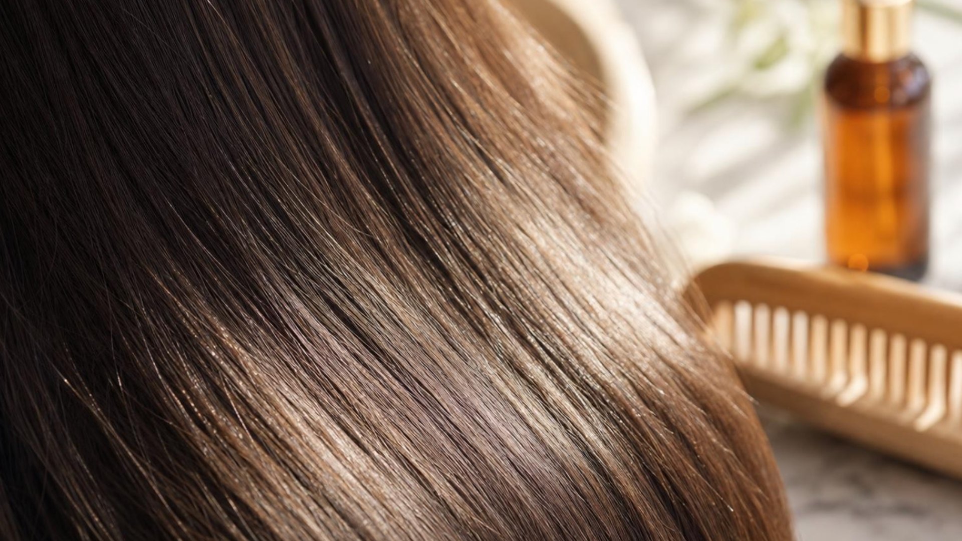 Woman using a hair straightener to style her hair